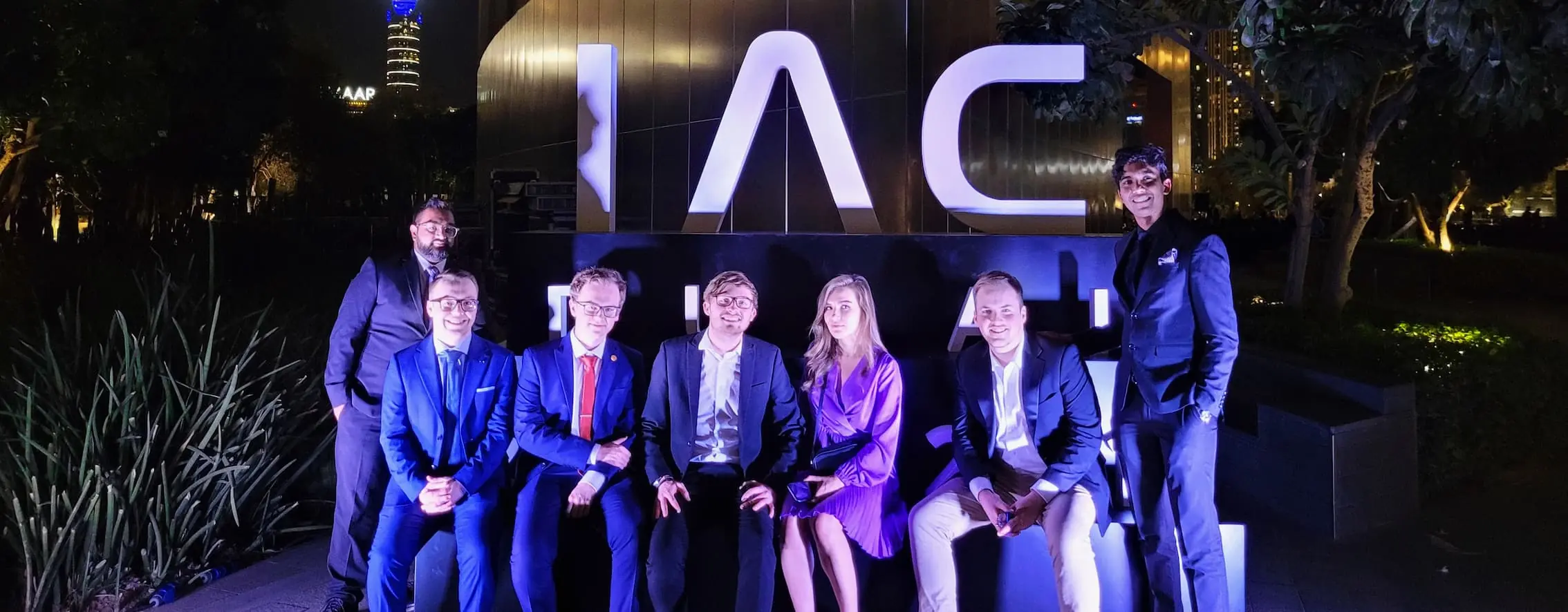 Members of the Conex team around an IAC sign at the Gala Dinner